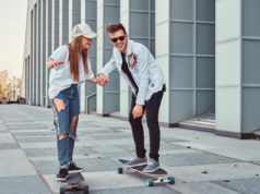 couple having fun while cruising longboarding