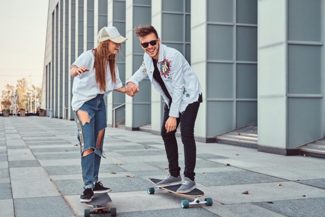 couple having fun while cruising longboarding